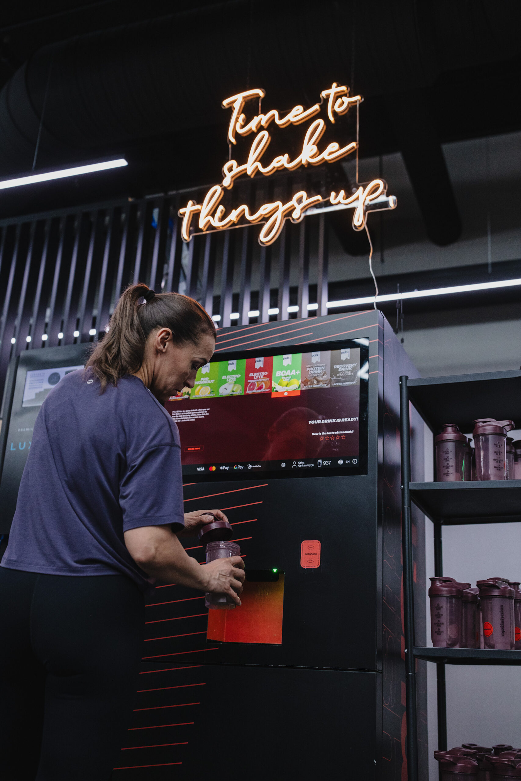 Pouring a fresh Optishake drink from the machine